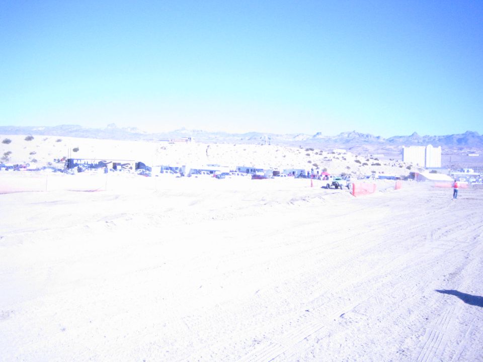 Overexposed wide view of a desert off-road racing pit area