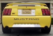 2002 Ford Mustang - Rear view of a yellow 2002 Ford Mustang GT, showing the distinctive taillights and GT badging.