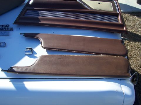 1978 Ford Bronco - Interior parts from a 1978 Ford Bronco are displayed on the vehicle's hood.