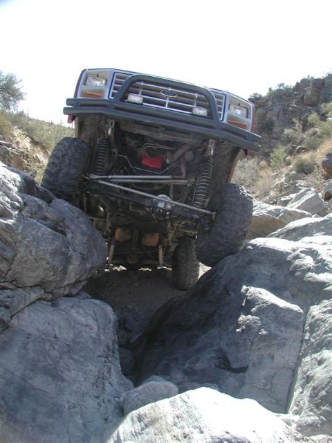 1994 Ford Bronco - This modified Ford Bronco is shown navigating a rocky trail with its front tires high off the ground.