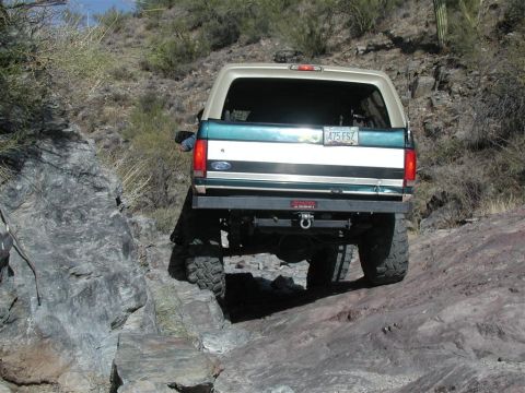 1994 Ford Bronco - This Ford Bronco navigates a challenging rocky trail, showing its rear end.