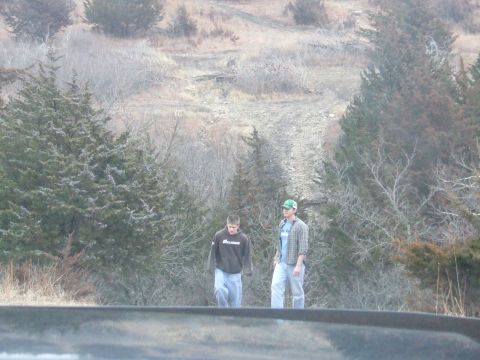 1994 Ford Bronco - Two men stand on a ridge overlooking a rural landscape with trees and a dirt path.