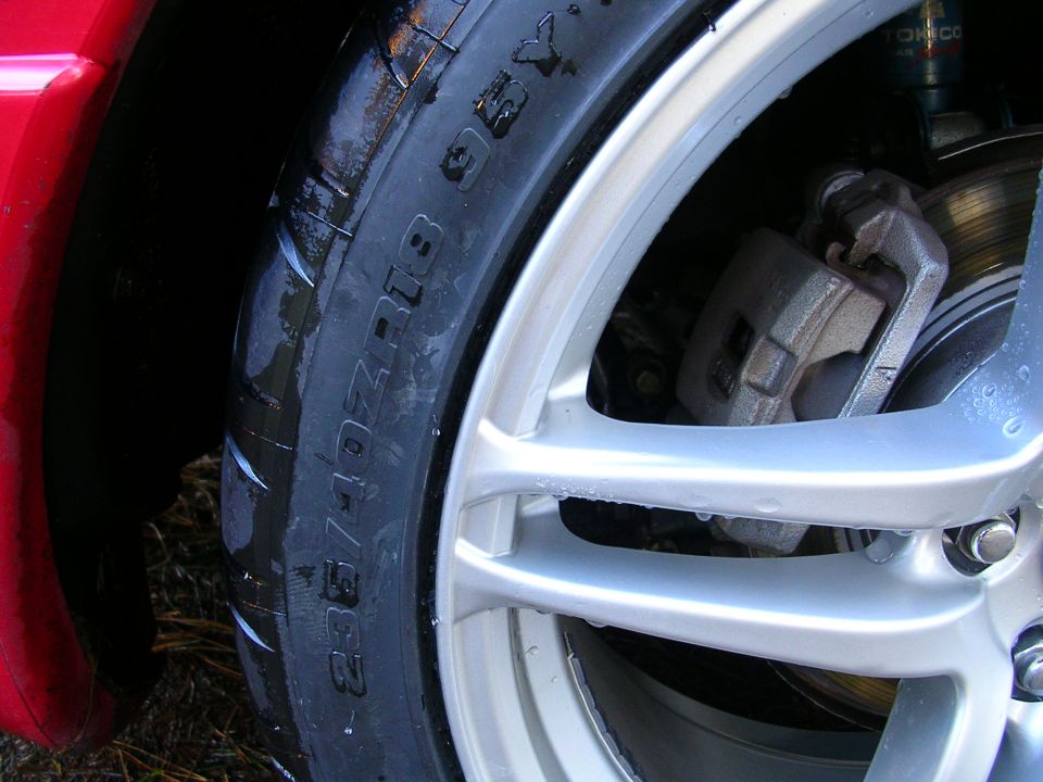 Close-up of a car wheel with tire showing size 235/40ZR18