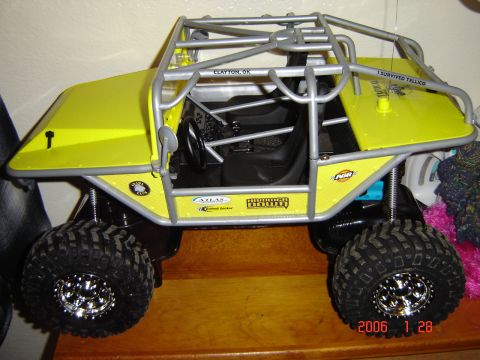 1993 Ford Bronco - This yellow off-road vehicle features a roll cage and racing decals, but does not match the claimed 1993 Ford Bronco.
