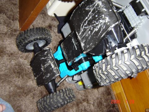 1993 Ford Bronco - This toy truck has a black body with white scuffs and large, knobby tires.