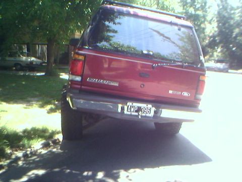 1996 Ford Explorer - The rear of a red SUV is visible, with the license plate AWP 396 clearly displayed.