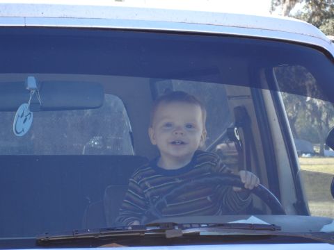 1989 Ford Bronco - Baby in driver's seat, holding the steering wheel.