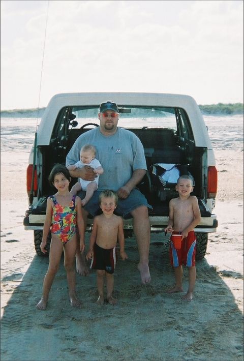 1989 Ford Bronco - Family poses in front of a 1989 Ford Bronco at the beach.