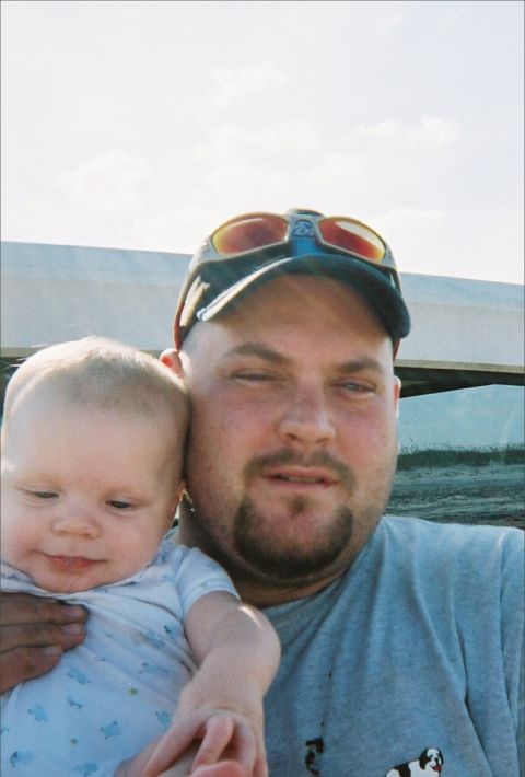 1989 Ford Bronco - A man and a baby pose for a selfie outdoors, with a watermark at the bottom.