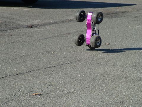 1994 Ford Bronco - A remote control monster truck is shown on its side on an asphalt surface.