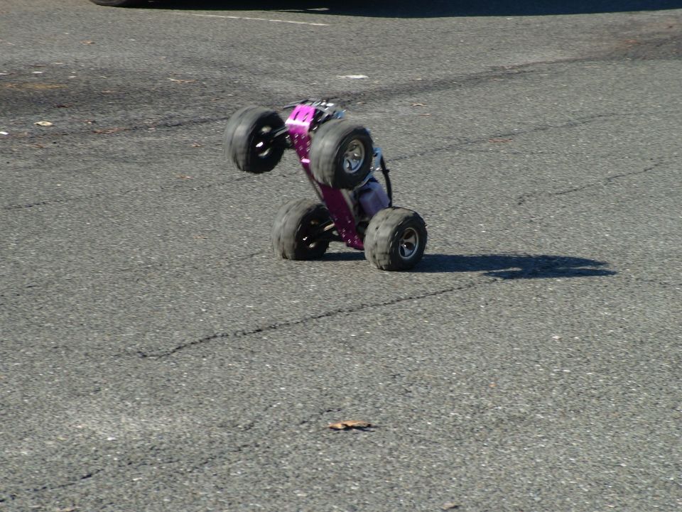 Purple remote control monster truck on two wheels