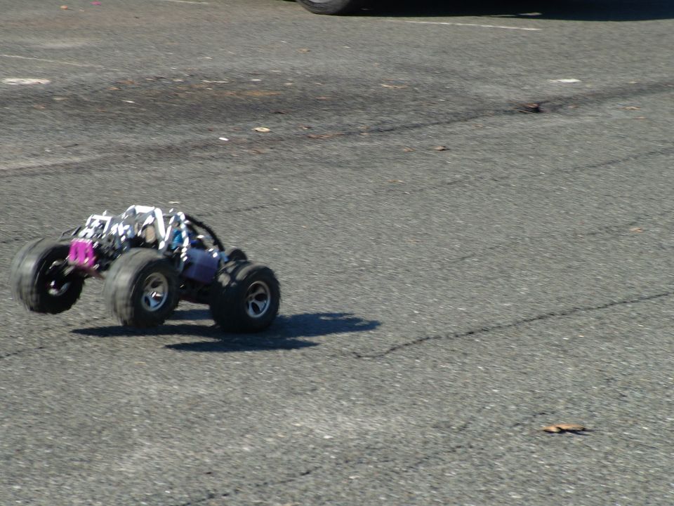 Remote control monster truck with large tires on asphalt