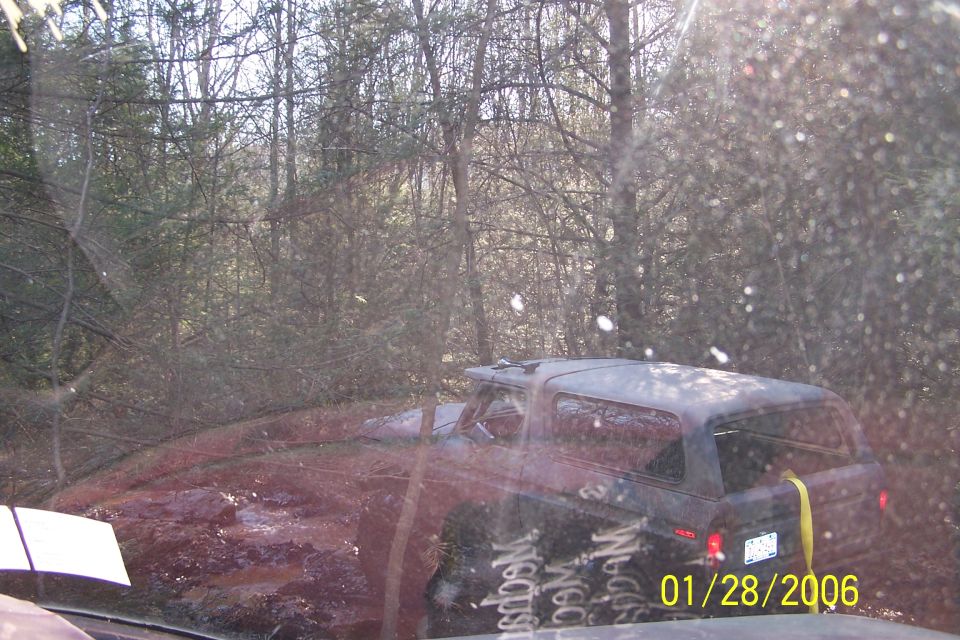 1979 Ford Bronco stuck in mud, rear quarter view