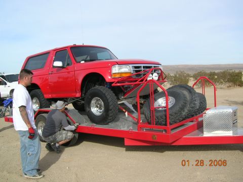 1985 Ford Bronco - A red 1992 Ford Bronco, modified for off-road use, is loaded onto a trailer.