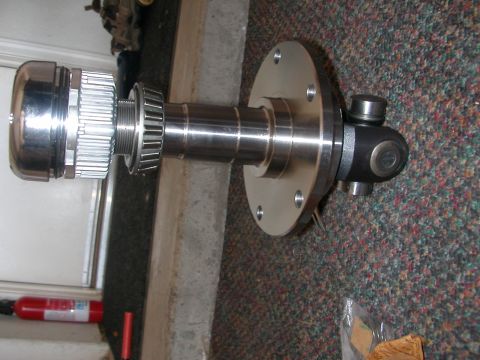 1984 Ford Bronco - Close-up of a differential axle assembly, likely a replacement part, with visible metal components and a U-joint.