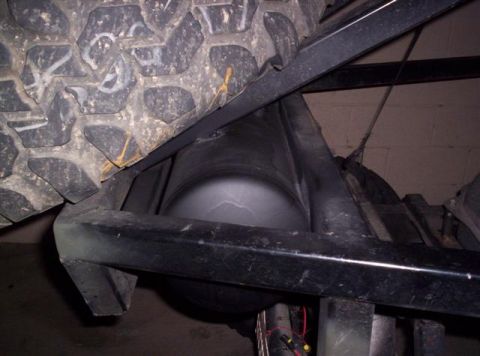 1987 Suzuki Samurai - Underside view of a vehicle showing an air tank and tire assembly.