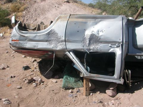 1984 Ford Bronco - This heavily damaged silver SUV is overturned and appears to be in a state of disrepair.