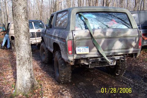 1979 Ford Bronco - This 1979 Ford Bronco is shown in a wooded area with other vehicles, likely off-roading.