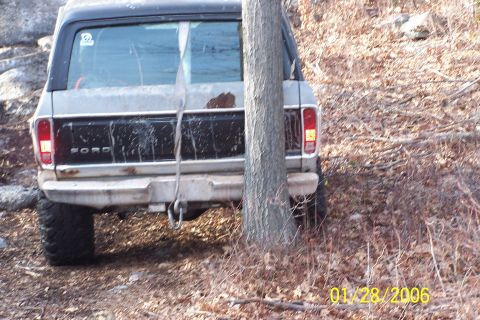 1979 Ford Bronco - Rear view of a 1979 Ford Bronco, showing the 'FORD' lettering on the tailgate and its off-road tires.