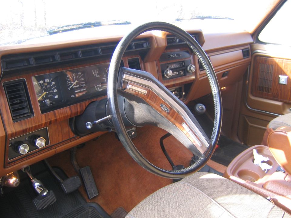 1978 Ford Bronco interior with wood grain trim, XLT badge, and brown upholstery