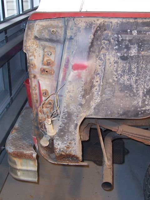 1978 Ford Bronco - This image shows the rear quarter panel and bumper area of a 1978 Ford Bronco, highlighting significant rust and damage.