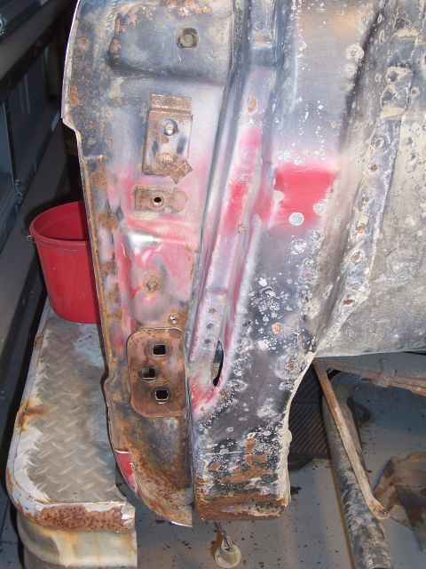 1978 Ford Bronco - The internal structure of a vehicle door shows significant rust and corrosion damage.