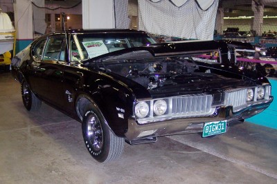 1972 Ford Ranchero - A black 1969 Oldsmobile 442 is displayed with its hood open, revealing the engine compartment.