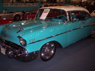 1972 Ford Ranchero - A turquoise and white 1957 Chevrolet Bel Air is displayed indoors, chrome accents and custom wheels.