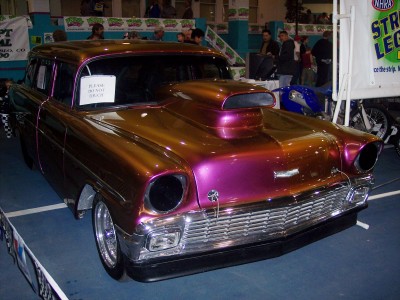 1972 Ford Ranchero - A customized station wagon with a prominent hood scoop is displayed indoors.