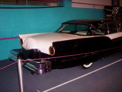 1972 Ford Ranchero - A vintage two-tone car with a distinctive grille and chrome accents is displayed indoors.