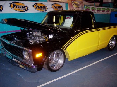 1972 Ford Ranchero - Custom pickup truck with a two-tone black and yellow paint scheme and racing stripes.