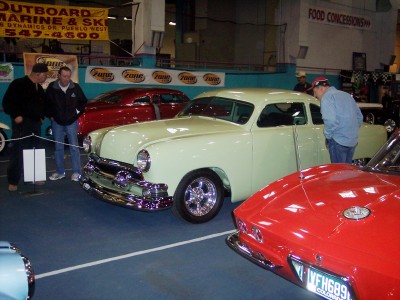 1972 Ford Ranchero - Several cars are on display indoors, with people looking at them.