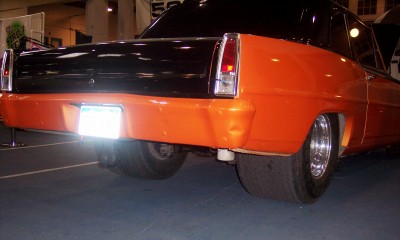 1972 Ford Ranchero - Custom pickup truck with a two-tone orange and black paint scheme and wide rear tires.