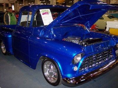 1972 Ford Ranchero - This 1955 Chevrolet pickup truck is on display with its hood open, revealing the engine bay.