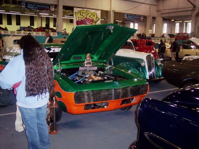 1972 Ford Ranchero - Custom car with open hood and flames on display at an indoor event.