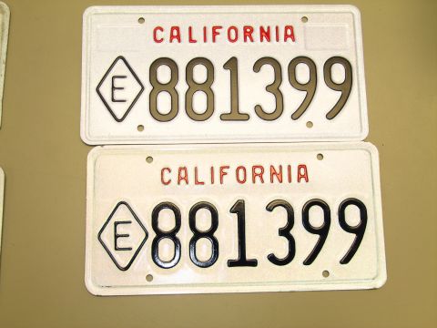 1991 Ford LTD Crown Victoria - Two white California license plates reading 881399 with an E-in-diamond symbol, displayed on a tan surface.
