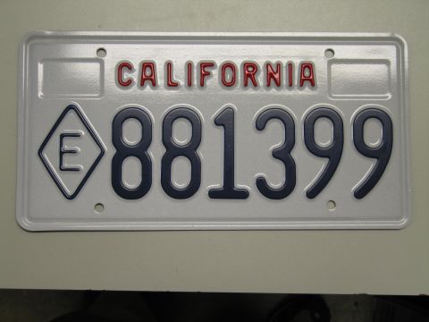 1991 Ford LTD Crown Victoria - white California license plate reading 881399 with an E-in-diamond symbol, photographed rotated sideways.
