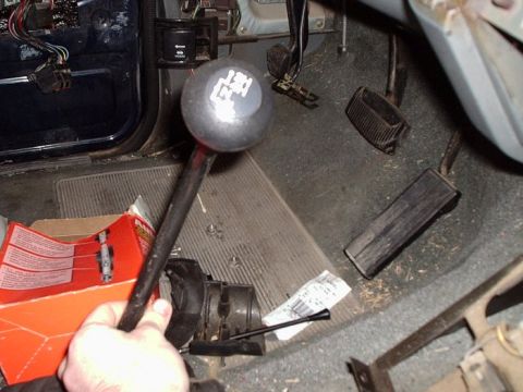 1990 Ford Bronco - Interior view of a 1990 Ford Bronco, highlighting the floor pedals and the 4WD gear shifter.