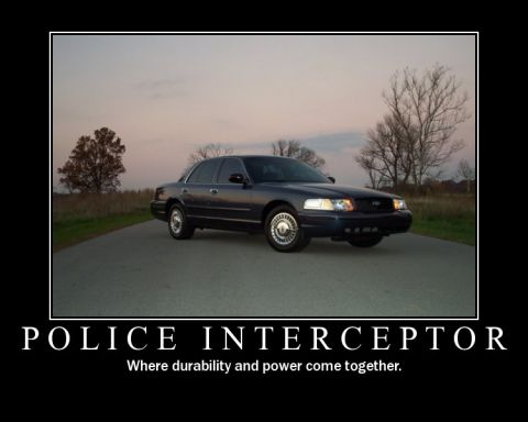 1998 Ford Crown Victoria - A 1998 Ford Crown Victoria Police Interceptor is shown in a three-quarter front view on a paved road.