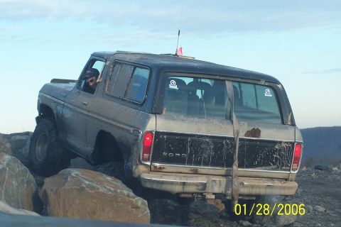 1979 Ford Bronco - This Ford Bronco is navigating a rocky trail, with its rear end facing the camera.