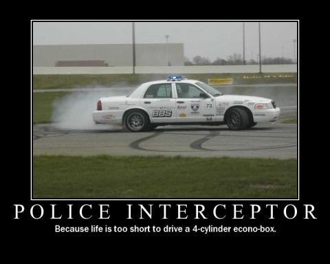 1998 Ford Crown Victoria - A 1998 Ford Crown Victoria police interceptor drifts on a track, demonstrating its power and agility.