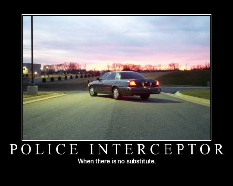 1998 Ford Crown Victoria - A police interceptor car is shown from the rear during a sunset.