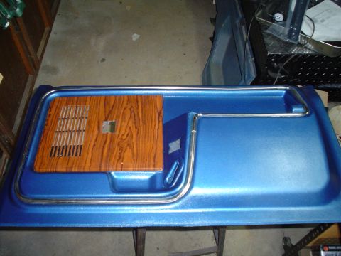 1984 Ford Bronco - A blue door panel with a wood grain accent and chrome trim is shown.