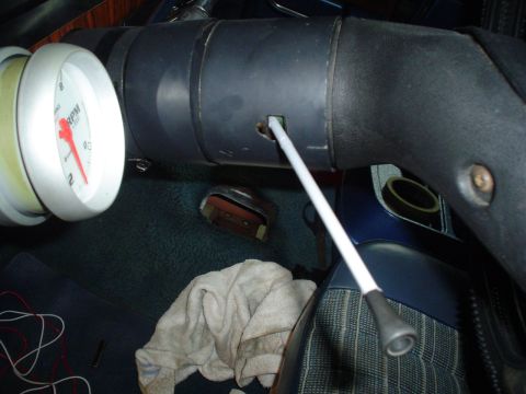 1984 Ford Bronco - Close-up view of a vehicle's interior, showing a tachometer and steering column details.