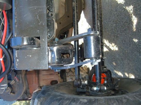 1993 Ford Bronco - A close-up view of a vehicle's suspension and tire, with visible text from Supermotors.net.