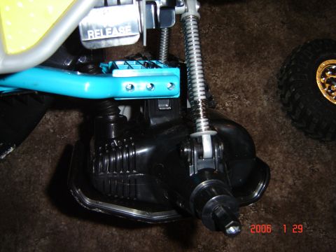 1993 Ford Bronco - Detail of a toy vehicle's suspension system, showing springs and a blue frame piece.