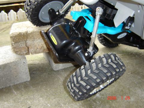 1993 Ford Bronco - Close-up of a remote control car's undercarriage, showing its suspension and drivetrain components.