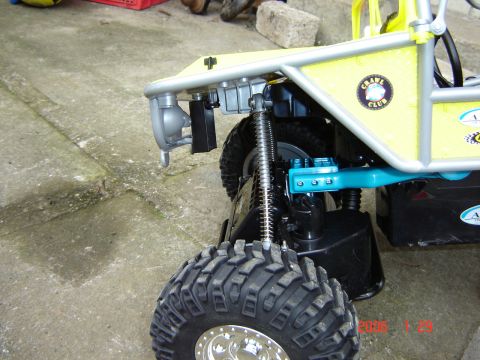 1993 Ford Bronco - Close-up of a yellow toy off-road vehicle, large tires and a 'Crawl Club' decal on its side.