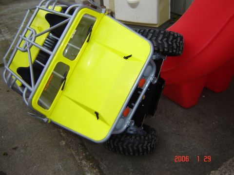 1993 Ford Bronco - This bright yellow RC truck appears to be a toy, possibly a rock crawler, tipped on its side.