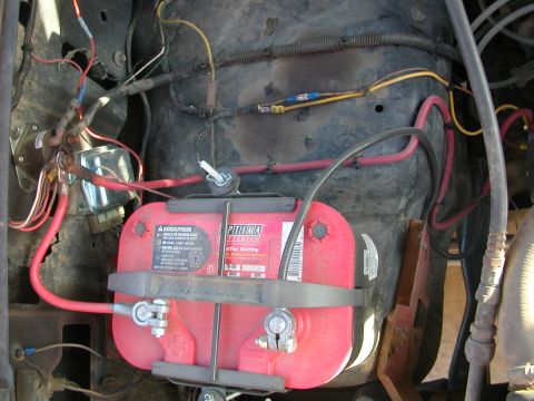 1984 Ford Bronco - The vehicle's electrical system is visible, centered around the battery and its connections.